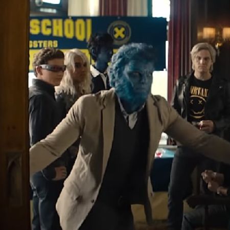 Beast is shutting down the door with other X-Men in the background.